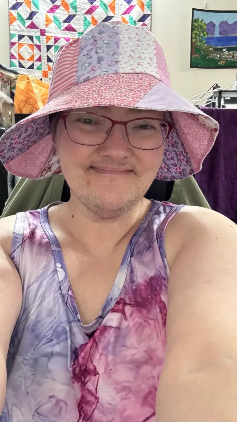 Louie wearing a colourful scrappy handmade Wave and Wild bucket hat